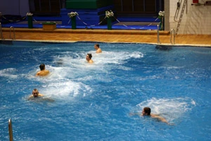 Divers in the indoor pool with splashes still visible after the group dive, 2005.