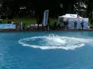Water after a landing and spectators beside the pool in the Reuters film.
