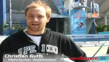 Filmstandbild: Christian Guth im Interview vor dem Sprungturm.